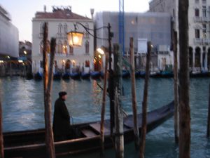 Image of Venice with man standing in gondola by Ewa Monika Zebrowski